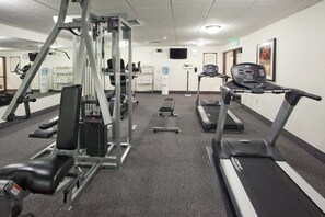 A gym with treadmills, weight machines, and benches. - King Suite with Full Kitchen | Free Breakfast (Great Falls)