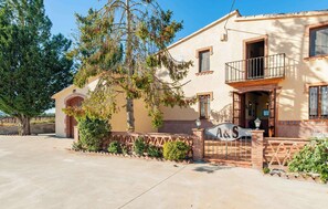 A two-story building with a balcony, a sign with 'A&S' on the front, and a tree in the foreground. - Country House with Vineyard Views, BBQ & Fireplace (El Pla del Penedès)