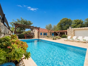 A swimming pool with lounge chairs, a pergola, and stone walls. - Didini Dvori - One Bedroom Villa, Sleeps 2 (Kruševo)