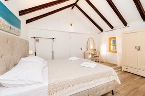 A bedroom with a bed, a dressing table, a wardrobe, and a painting on the wall. - Didini Dvori - One Bedroom Villa, Sleeps 2 (Kruševo)