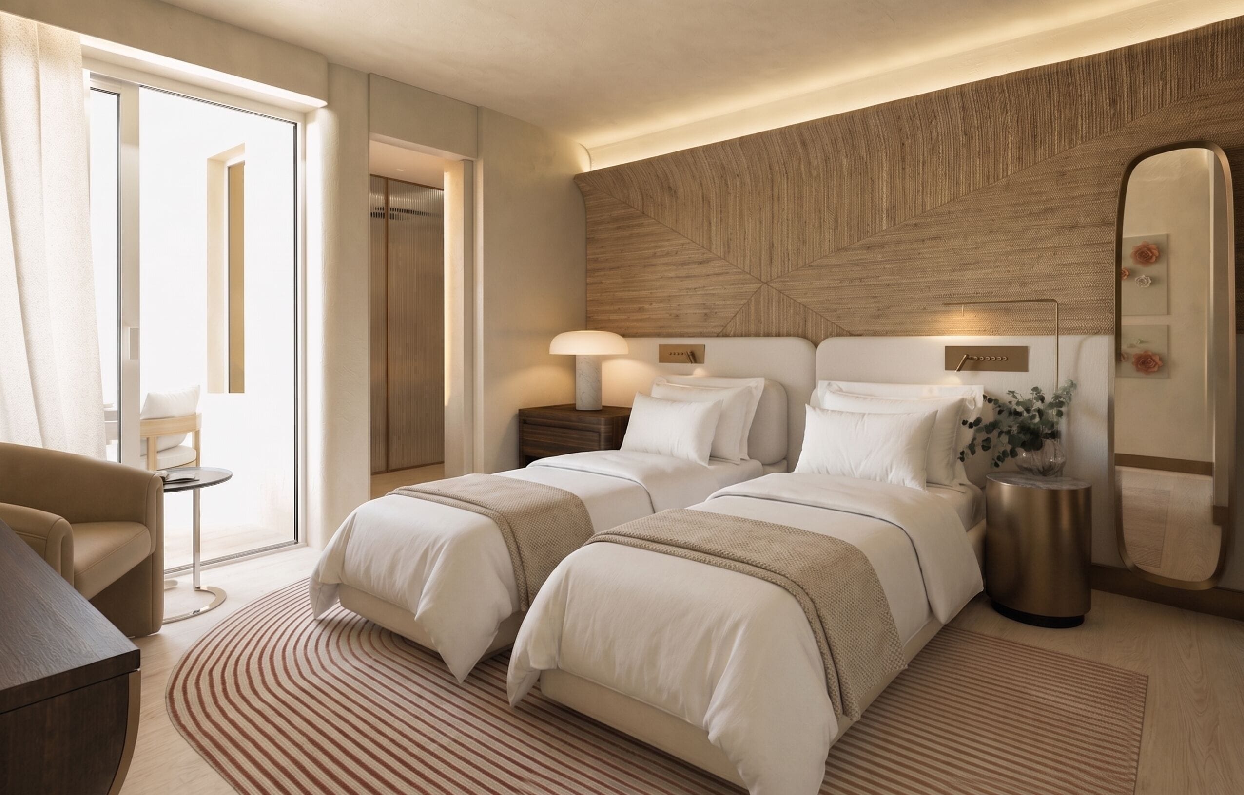 A hotel room with two beds, a sitting area, a large mirror, and a wooden accent wall.