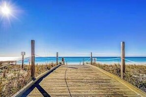 A wooden boardwalk leading to a beach with a clear sky. - 2BR Condo - Shared Pool, Hot Tub & Tennis Courts (Destin)