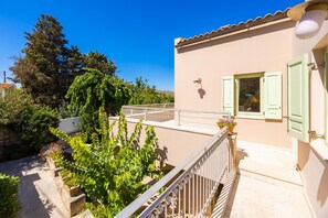 A building with a balcony, a window with shutters, and a door. - Villa Verde Petra - Three Bedroom Villa, Sleeps 6 (Armeni)