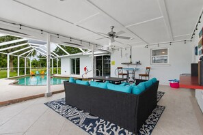 A covered outdoor area with a pool, seating, and a ceiling fan. - Chuck & Margies Coastal Escape (Cortez)