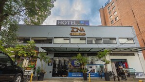 Ein Hotel mit einem Schild für ZONA EXPRESS, einem Parkplatz und einem Gebäude mit vielen Fenstern.