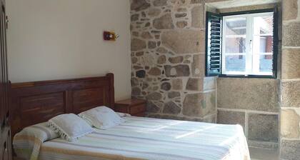 A rustic family home located in a village in Galicia, surrounded by countryside