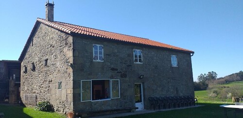 A rustic family home located in a village in Galicia, surrounded by countryside