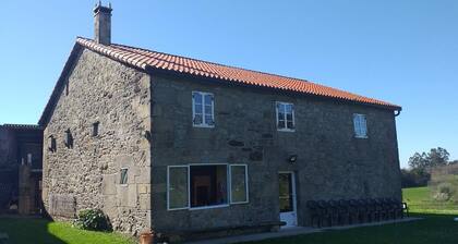 A rustic family home located in a village in Galicia, surrounded by countryside