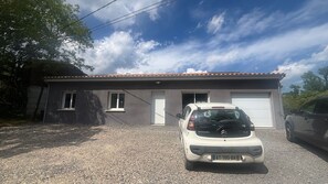 A single-story building with a gravel driveway and a parked Citroen C1 car in front. - Villa “Des Rives Et Chevaux 07” in the Heart of Val de Ligne, Southern Ardèche (Montréal)