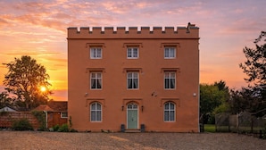 A two-story building with a symmetrical facade, multiple windows, and a central entrance.