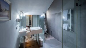 A modern bathroom with a glass shower enclosure, a white sink, and a large mirror. - Dolce Vita Appartement (La Marsa)