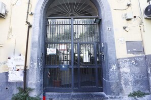 A black metal gate with a sign indicating a mobile phone rental service. - GuestHost - Aunt Maria's Little House (Naples)