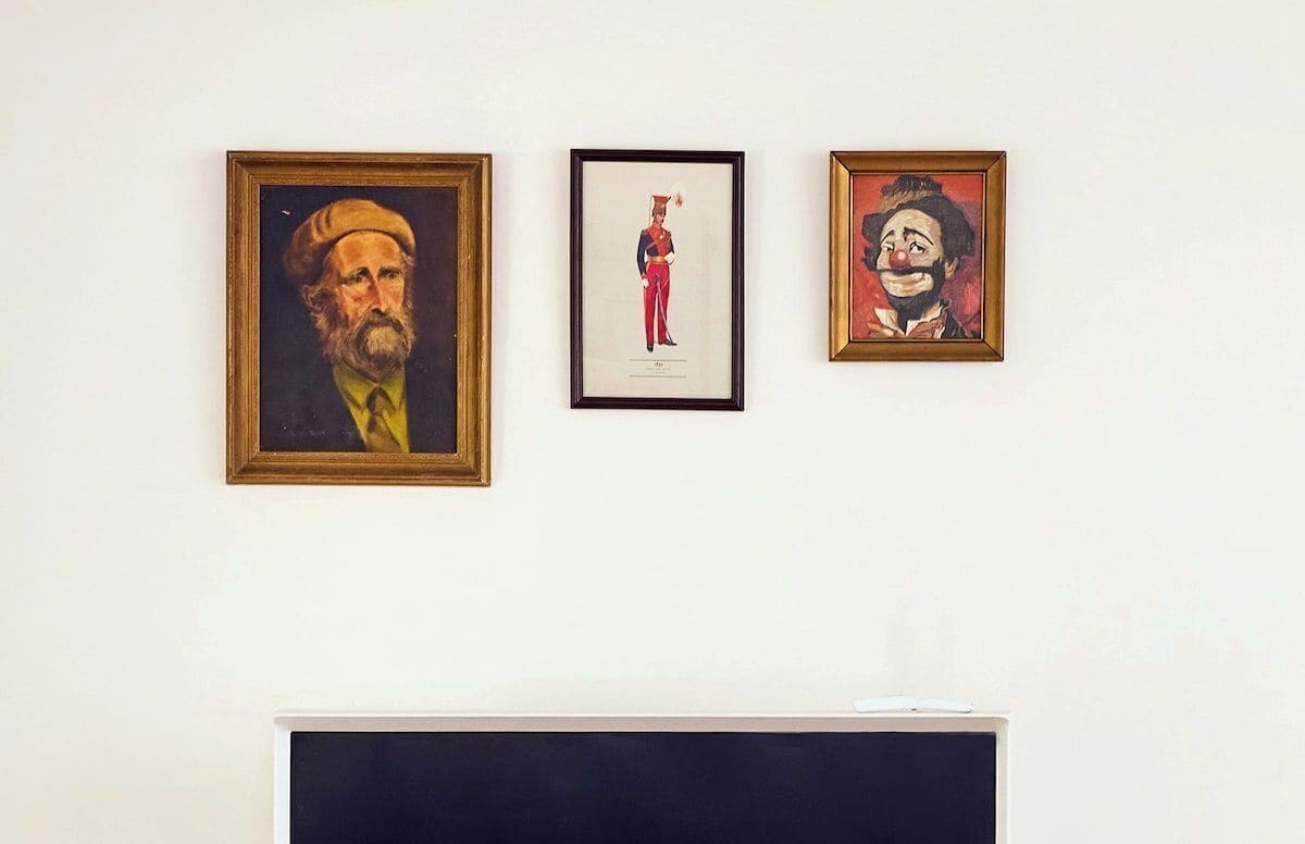 Three framed artworks on a wall.