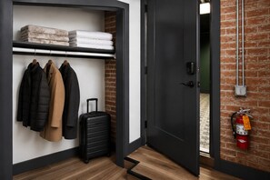 A hotel room with a wardrobe, a suitcase, and a fire extinguisher. - The Verdict (Port Clinton)