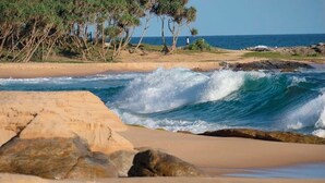 A beach with waves, rocks, and trees. -  Araliya Villa- Luxury 3-Bedrooms, Private Pool & Sea Views. Breakfast Included. (Rekawa Road)