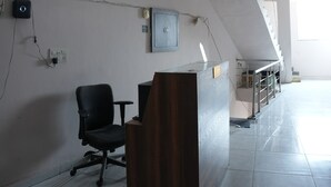 A room with a desk, chair, and a staircase. - Hotel Hari sarovar (Kurukshetra)