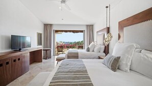 A hotel room with a bed, a TV, a desk, and a balcony with a view. - Presidential 2-bedroom suite in enchanting San José del Cabo (San José del Cabo)