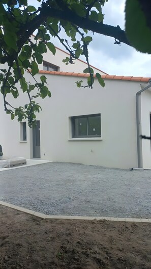 A building with a white exterior, a window, and a door.