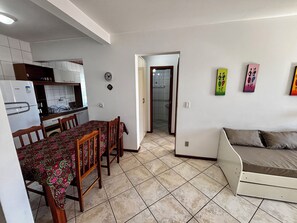 A compact living space with a kitchenette, dining area, and a sofa. - Unleash your best self by the sea! (Florianópolis)