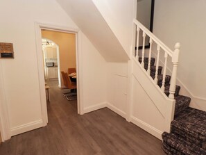 A hallway with a staircase leading to a dining area. - William's Place (Barry)