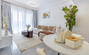 A modern living room with a sofa, coffee table, and decorative items.