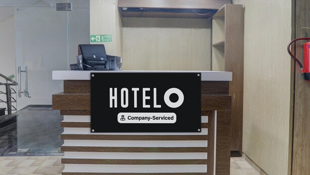 A reception desk with a sign indicating 'HOTEL' and 'Company-Serviced.' - Classic Medical College Basaratpur (Gorakhpur)