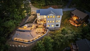 A multi-story house with a patio area, a separate building with a deck, and a driveway. - New! Views, Sauna Spa Hottub Cantina, Dogs (Gatlinburg)