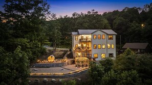 A multi-story hotel with a balcony and outdoor seating area, surrounded by trees. - New! Views, Sauna Spa Hottub Cantina, Dogs (Gatlinburg)