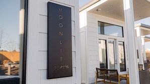 A modern building exterior with a vertical sign reading 'MOONLIGHT grove'. - Boutique Spa Resort Adults-Only | Designed for Relaxation (Idaho Falls)