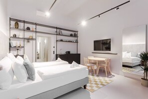 Ein modernes Hotelzimmer mit Bett, Schreibtisch und Fernseher.