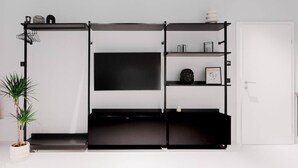 Una sala de estar moderna con un mueble de entretenimiento negro, un televisor de pantalla plana y una planta en maceta.
