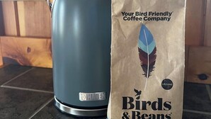 A coffee maker and a bag of Birds & Beans American Redstart Light Roast coffee on a kitchen counter. - Cozy cabin on a homestead surrounded by animals - enjoy a fire pit & fresh eggs (Independence)