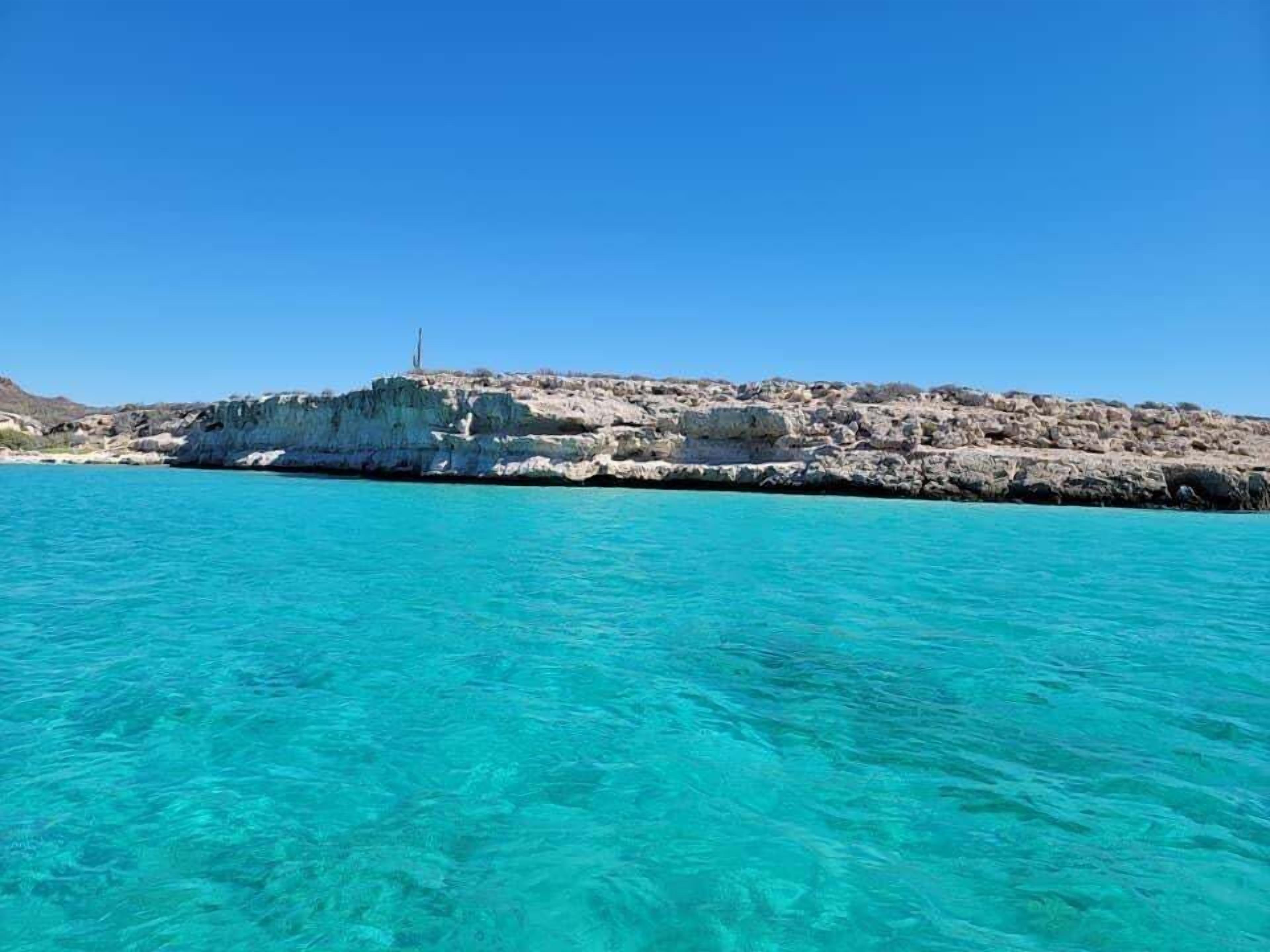 A rocky coastline with clear turquoise water.