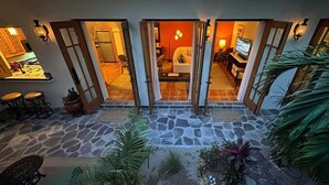 A courtyard with stone flooring, a dining area with chairs and a table, and a kitchen visible through an open door. - Newly Renovated Home- 5 Steps From LAP Pool (  Loreto)