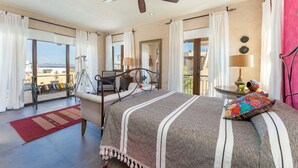 A bedroom with a bed, a ceiling fan, a balcony with a view, and a window. - Home With Stunning Ocean View and Breathtaking Sights of the Sierra La Giganta (  Loreto)