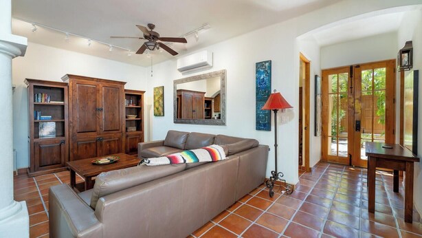 A living room with a sofa, wooden cabinets, a ceiling fan, and a tiled floor. - Oceanview Escape With Rooftop Terrace & Mountain Views Welcome to Your Perfect Coastal Retreat! (FN397 Loreto)