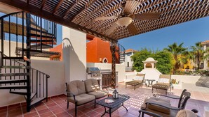 A patio with outdoor furniture, a grill, and a staircase. - Amazing Home a few Steps to the Beach (  Loreto)