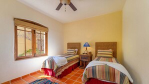 A room with two beds, a window, a ceiling fan, and a tiled floor. - Amazing Home a few Steps to the Beach (  Loreto)