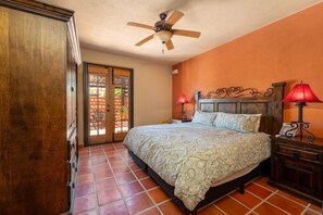 A bedroom with a bed, two bedside lamps, a ceiling fan, and a wooden wardrobe. - Water and Mountain Views-steps to Beach and Inn (  Loreto)