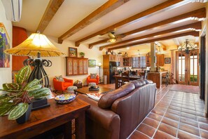 A spacious living area with a sofa, a dining table, and a kitchen in the background. - Near the Beach! Wonderful House (  Loreto)