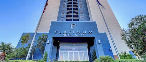 The exterior of the Platinum Hotel & Spa, featuring a modern design with a prominent entrance and a flagpole.
