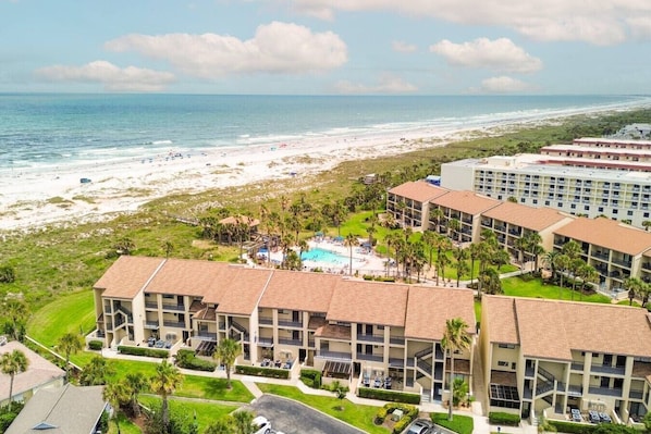 A resort with multiple buildings, a swimming pool, and a beach view. - Seaside Escape - Private beach and pool! (St. Augustine Beach)