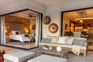 Ein modernes Hotelzimmer mit Bett, Sofa, Couchtisch und dekorativen Tellern an der Wand.