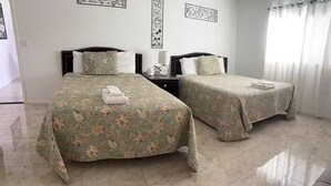 A hotel room with two beds, a nightstand, a lamp, and artwork on the walls. - Ani place  . (Las Vegas)