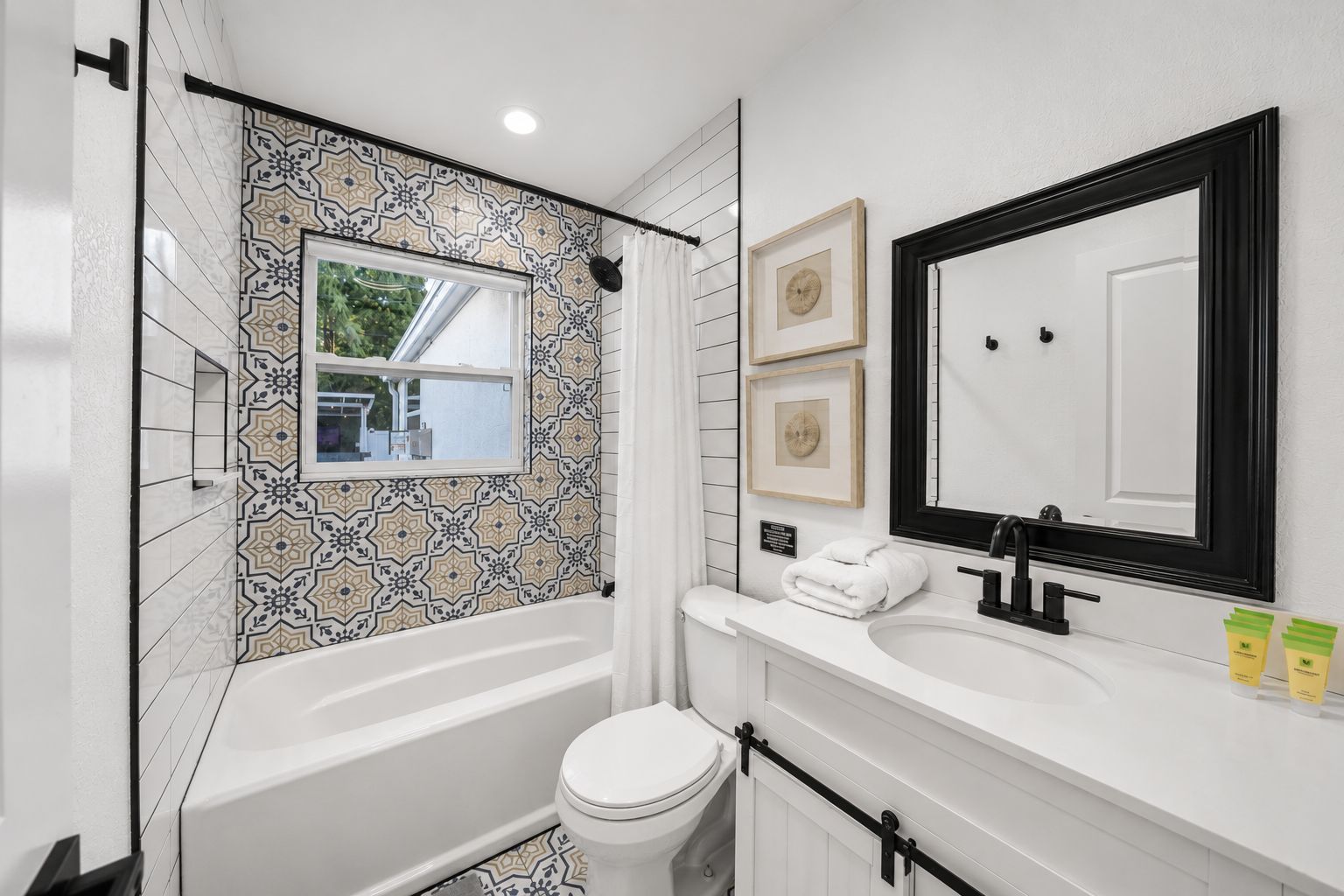 A bathroom with a bathtub, toilet, and sink.