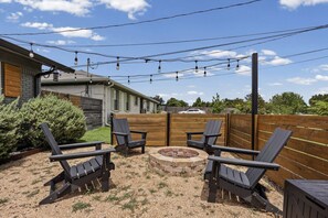 An outdoor seating area with Adirondack chairs and a fire pit. - Casa Verde! Mid Century Charmer in Old Town. Walk to SWU and The Square! (Georgetown)