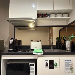 A kitchenette with a coffee maker, toaster, sink, and a microwave. - Balcony & Kitchen · Pool, Gym, Fast Wi-Fi (Watthana)