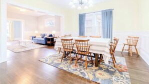 A dining area with a table and chairs, a chandelier, and a view through a window. - Historic Home Downtown Gary Near BP/80/94 Hospital (Gary)