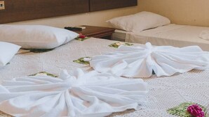A hotel room with a bed, pillows, a nightstand, and a headboard. - HOTEL SOL BAHIA (Porto Seguro)