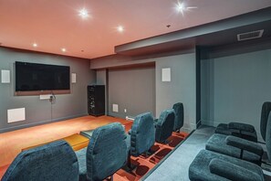 A movie theater with rows of seats, a large screen, and a sound system. - Montreal - C Lofts Le Smith 2 Bedroom (Montreal)
